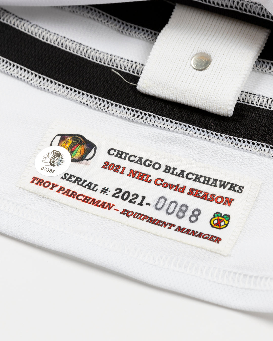 red Chicago Blackhawks home jersey with Vinnie Hinostroza name and number - covid patch detail lay flat