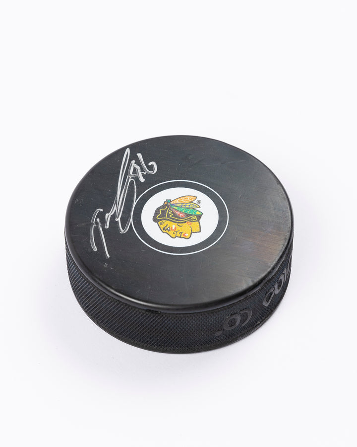 hockey puck signed by Chicago Blackhawks player Teuvo Teravainen - angled lay flat