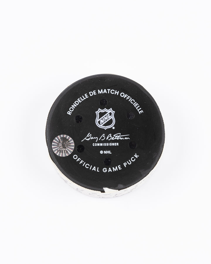 game used hockey goal puck scored by Chicago Blackhawks player Craig Smith on game on October 19, 2024 - back lay flat