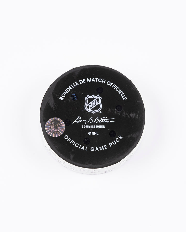 game used hockey goal puck scored by Chicago Blackhawks player Tyler Bertuzzi during game on October 22, 2024 - back lay flat