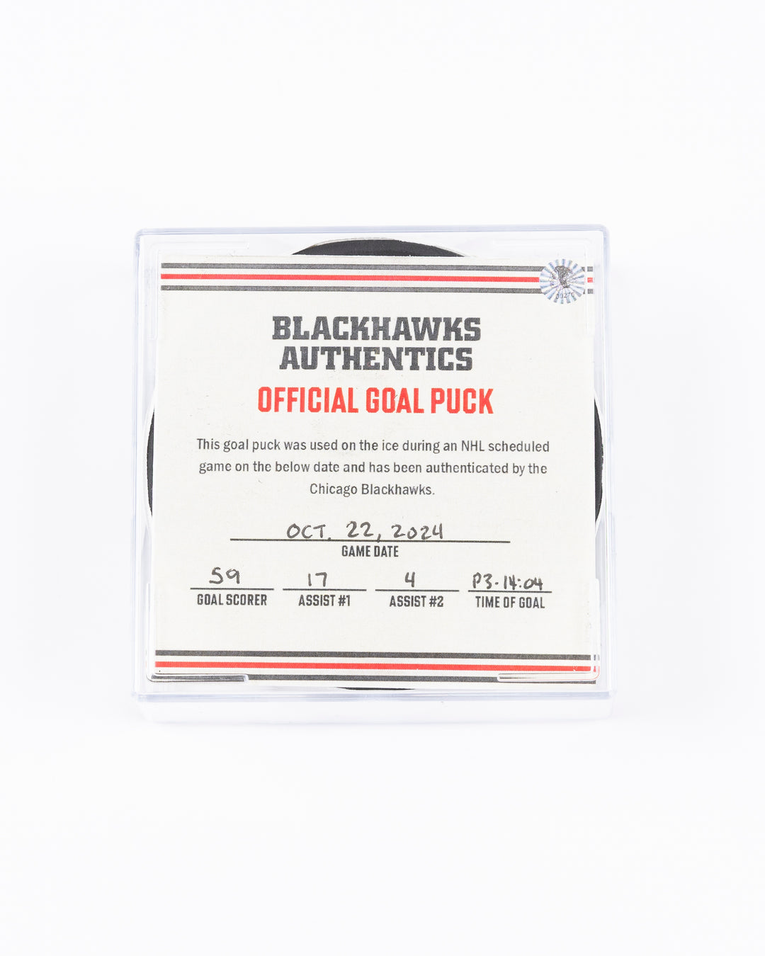 game used hockey goal puck scored by Chicago Blackhawks player Tyler Bertuzzi during game on October 22, 2024 - front lay flat in case