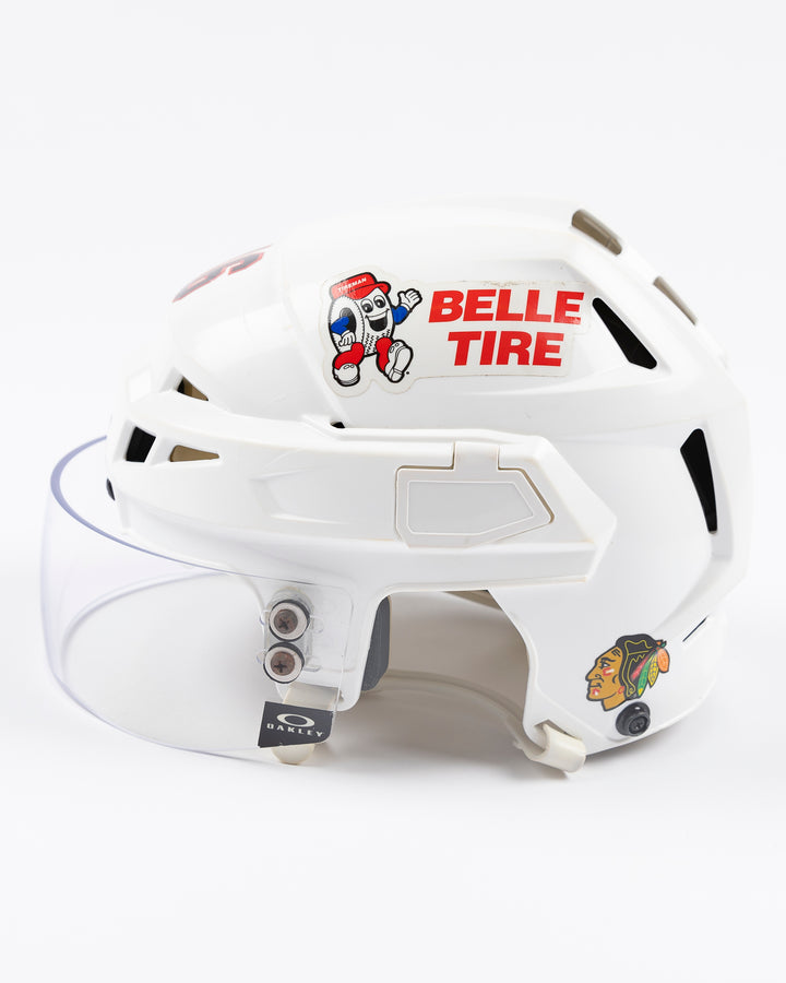 white CCM hockey helmet used by Chicago Blackhawks player Jason Dickinson - left side lay flat