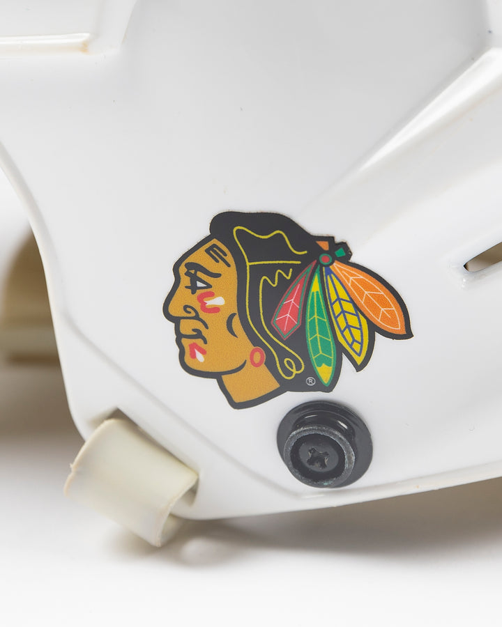 white CCM hockey helmet used by Chicago Blackhawks player Jason Dickinson - alt detail lay flat