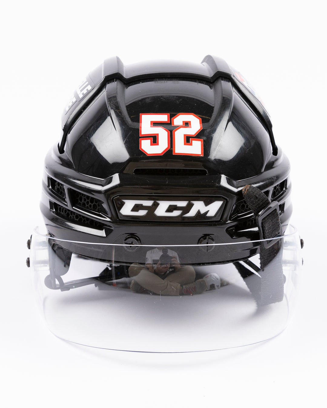 black CCM hockey helmet worn by Chicago Blackhawks player Reese Johnson - front lay flat