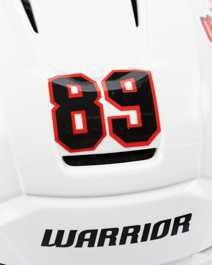 white Warrior hockey helmet worn by Chicago Blackhawks player Andreas Athanasiou - number detail lay flat