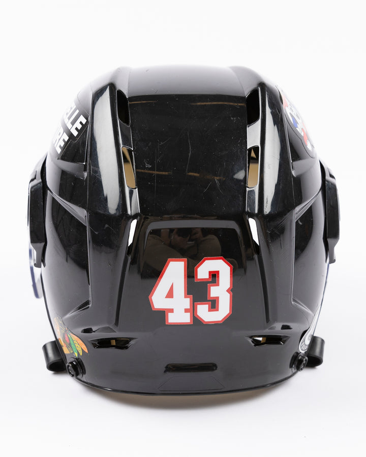 black CCM hockey helmet with number 43 worn by Chicago Blackhawks player Colin Blackwell - back lay flat