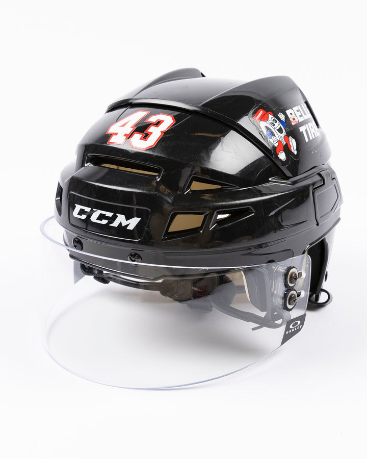 black CCM hockey helmet with number 43 worn by Chicago Blackhawks player Colin Blackwell - left angle lay flat