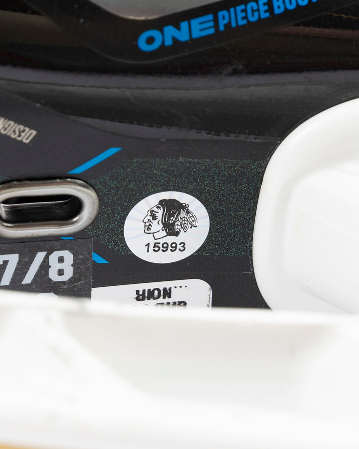 black CCM hockey skates worn and used by Chicago Blackhawks player Jason Dickinson - hologram sticker detail lay flat