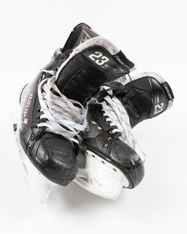 black Bauer hockey skates worn by Chicgo Blackhawks player Philipp Kurashev - front lay flat