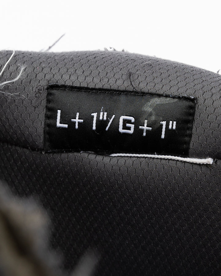 black Bauer hockey pants used by unspecified Chicago Blackhawks player - size tag detail lay flat