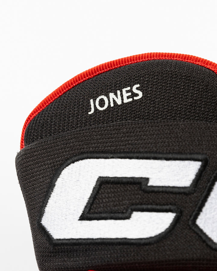 black CCM hockey gloves used by Chicago Blackhawks player Seth Jones - name detail lay flat