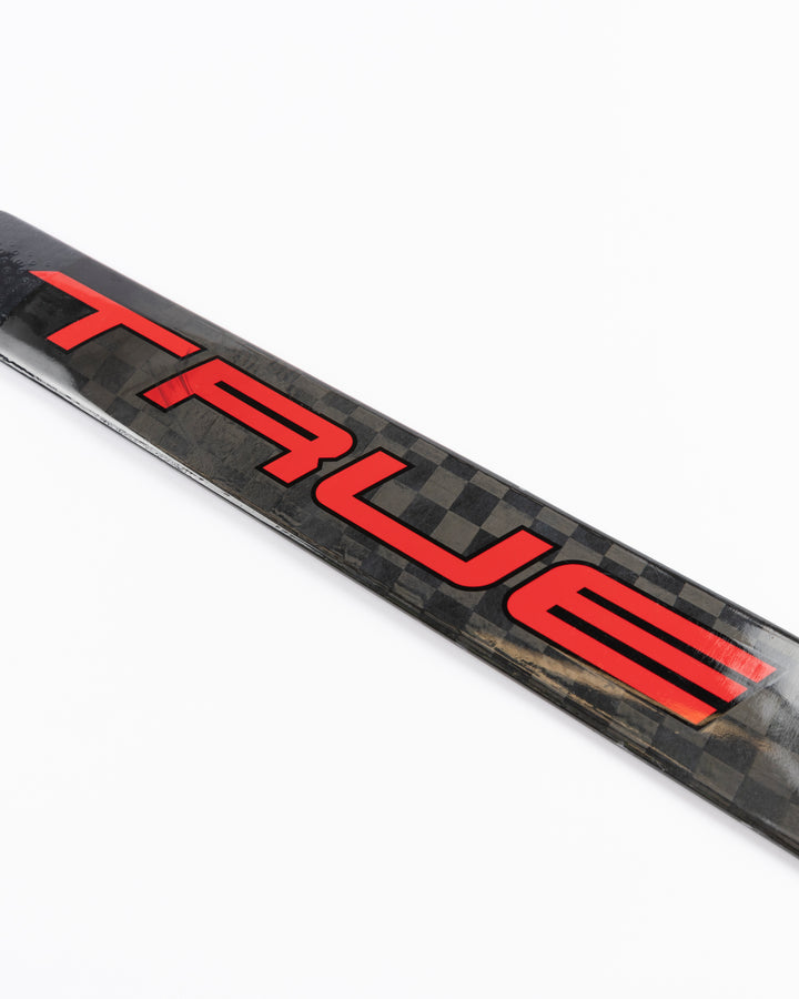 black TRUE hockey stick used by Chicago Blackhawks goalie Arvid Soderblom - TRUE logo detail lay flat