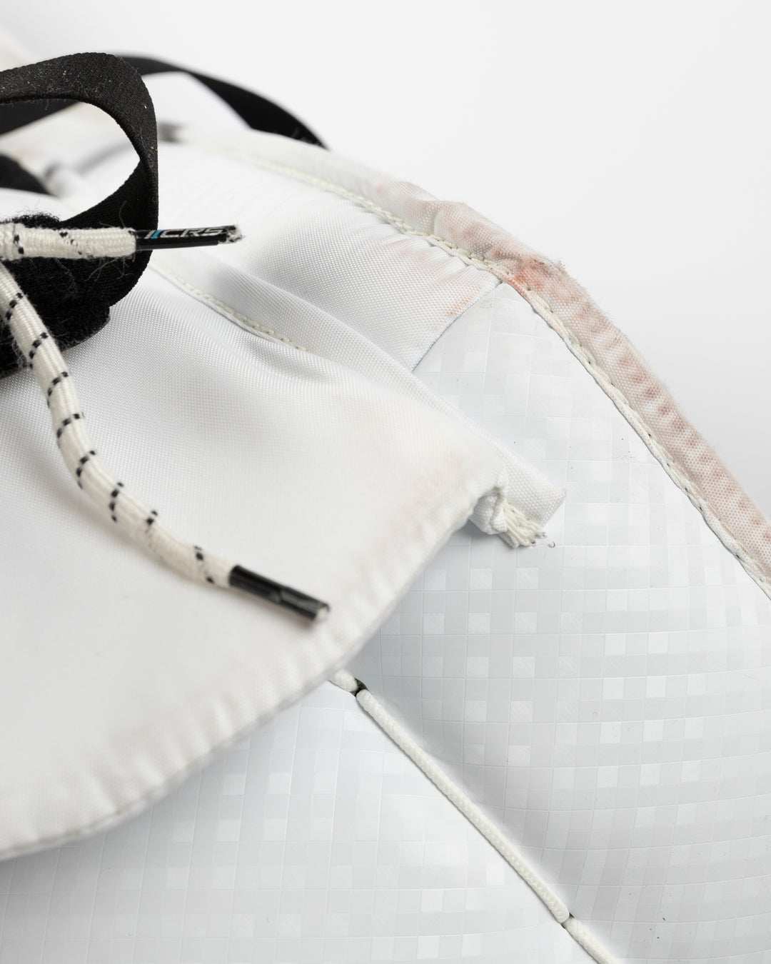 white Vaughn goalie pads used by Chicago Blackhawks goalie Petr Mrazek - lace detail lay flat