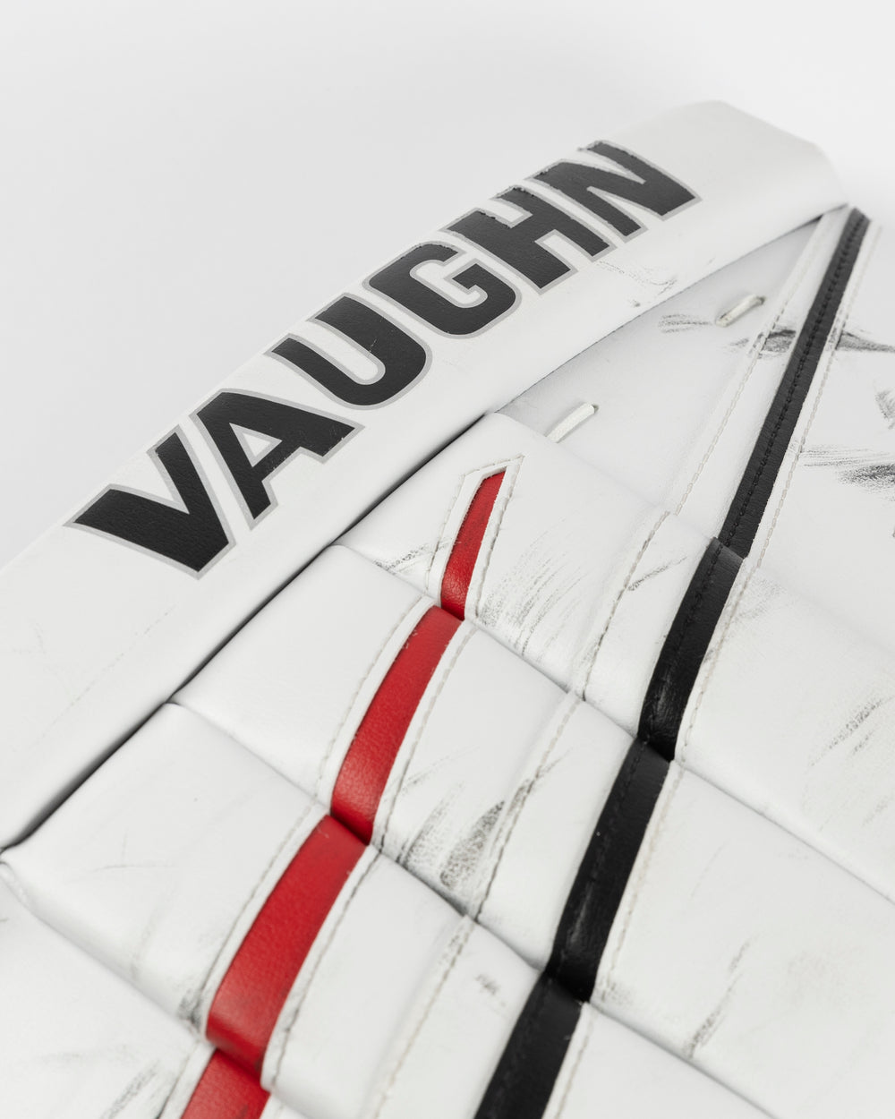 white Vaughn goalie pads used by Chicago Blackhawks goalie Petr Mrazek - logo and scuff detail lay flat