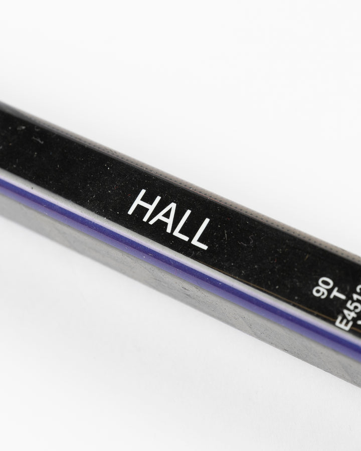 black CCM hockey stick used by Chicago Blackhawks player Taylor Hall - name detail lay flat