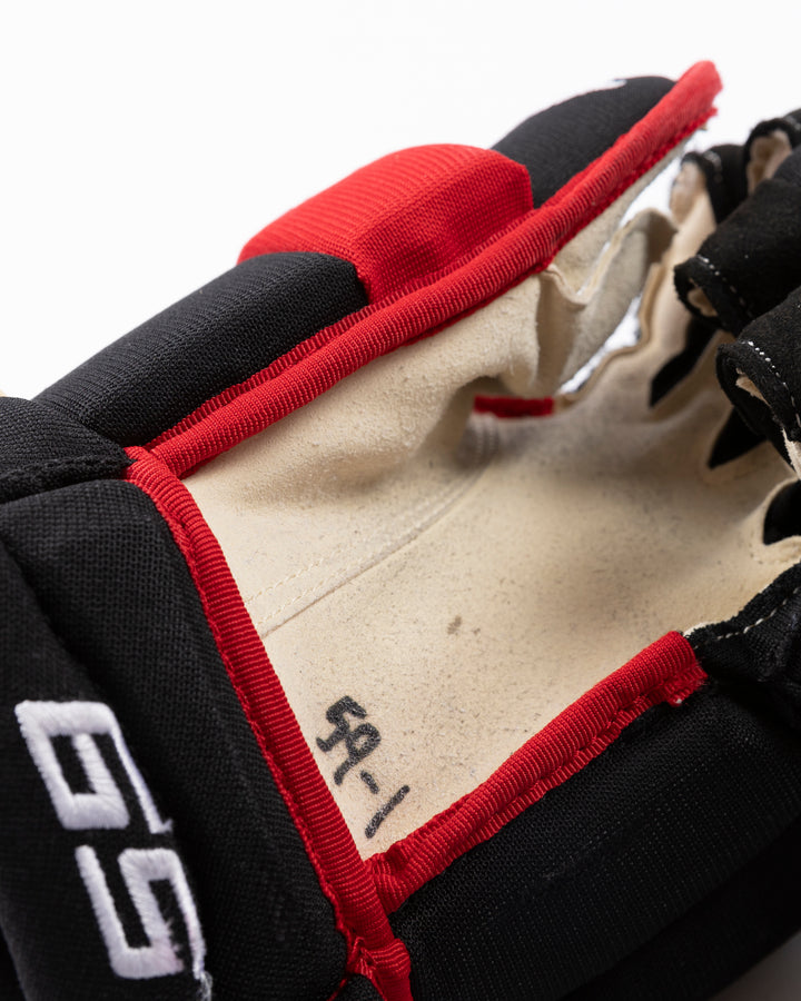 black TRUE brand hockey gloves used by Chicago Blackhawks player Tyler Bertuzzi - alt detail lay flat