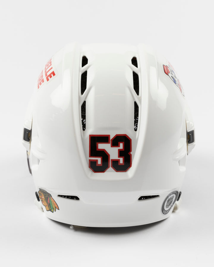 white CCM hockey helmet used by Chicago Blackhawks player Marcel Marcel - back lay flat