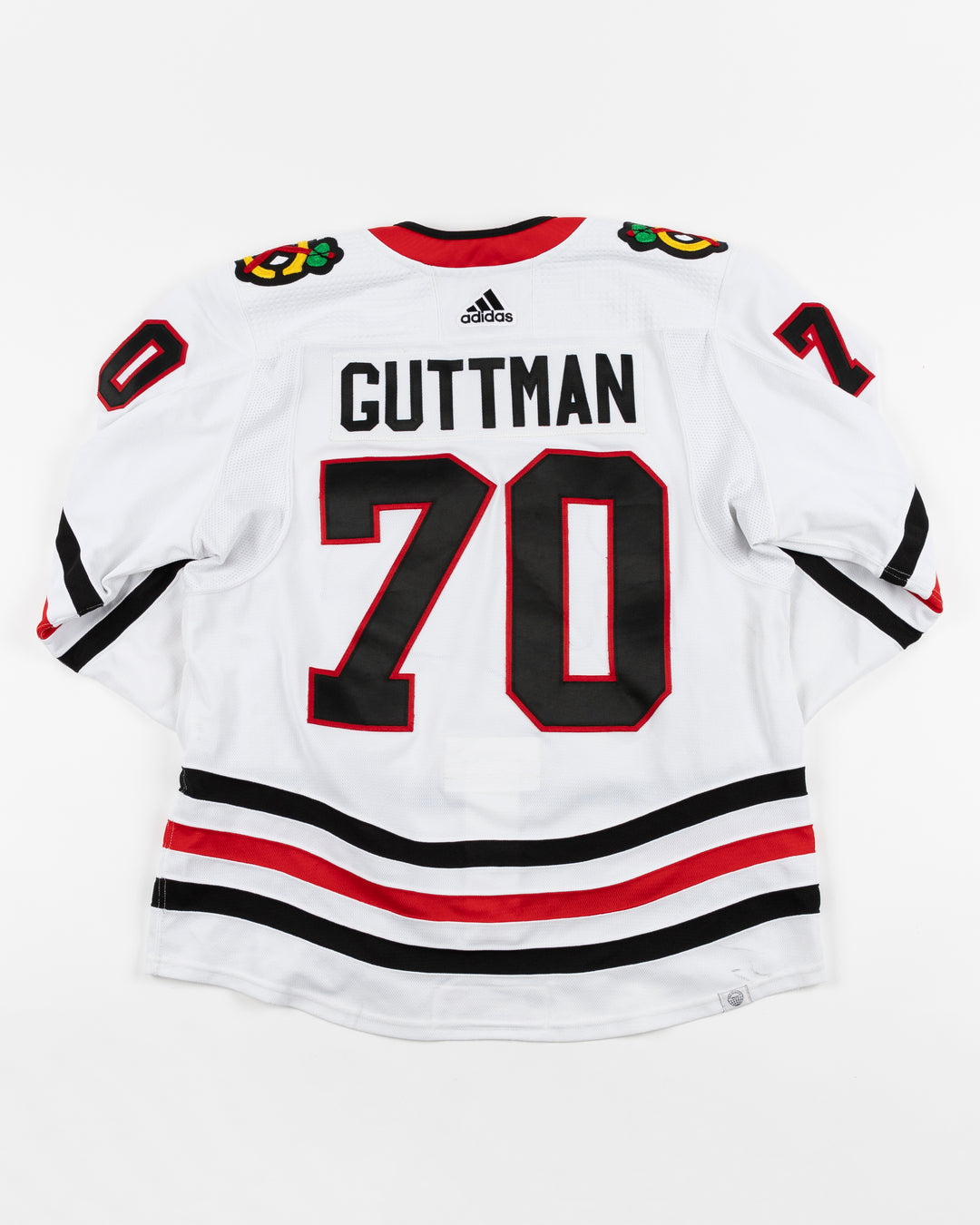 white adidas Chicago Blackhawks away jersey game used by Blackhawks player Cole Guttman - back lay flat