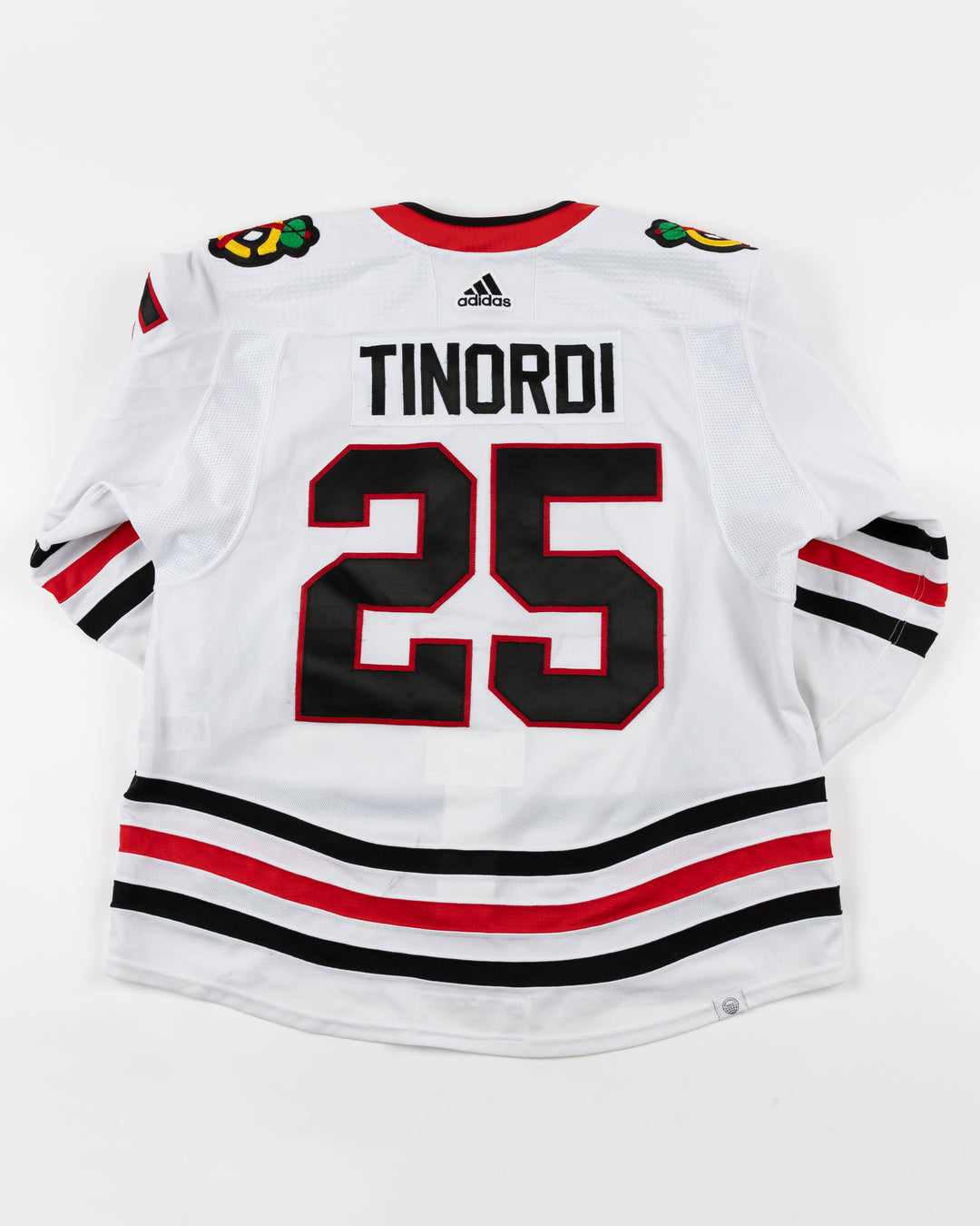 white adidas Chicago Blackhawks away jersey game used by Jarred Tinordi - back lay flat