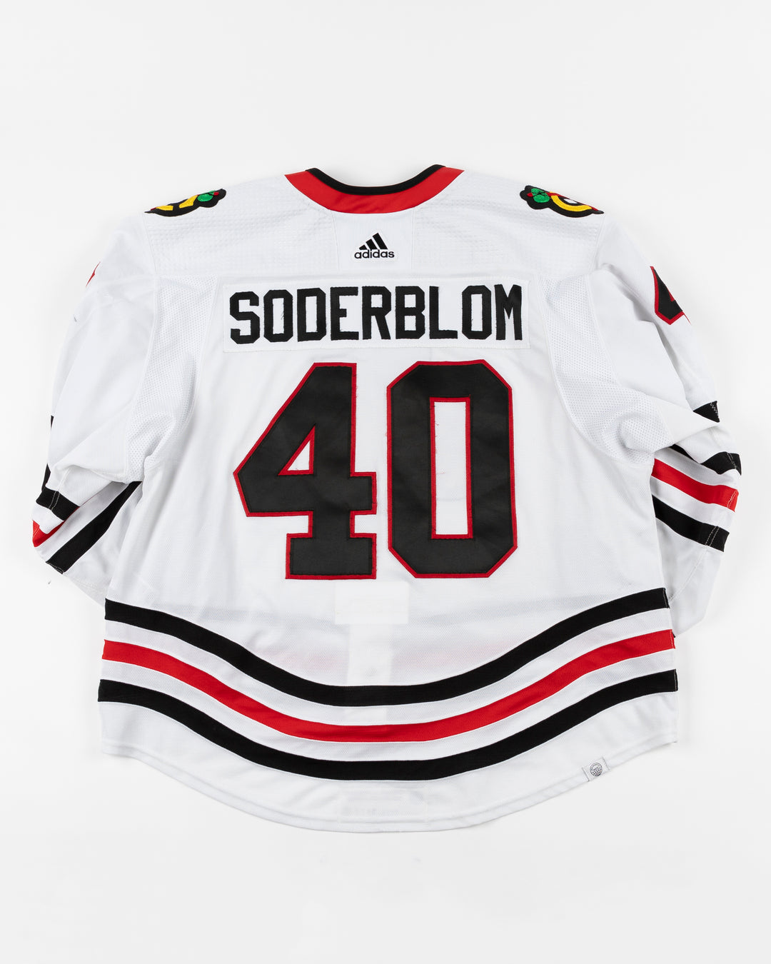 white Chicago Blackhawks adidas away jersey game used by Arvid Soderblom - back lay flat