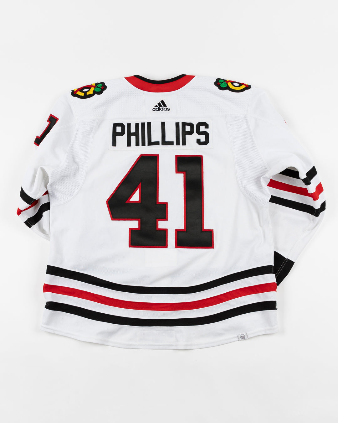 white adidas Chicago Blackhawks away jersey game used by player Isakk Phillips - back lay flat