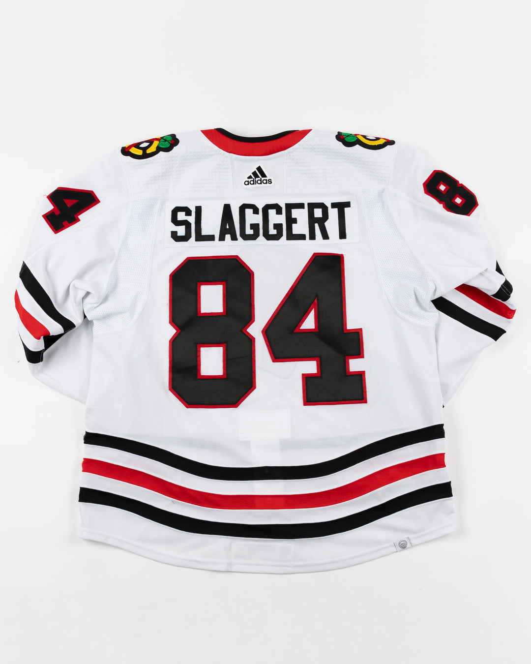 white adidas Chicago Blackhawks away jersey game used by player Landon Slaggert - back lay flat