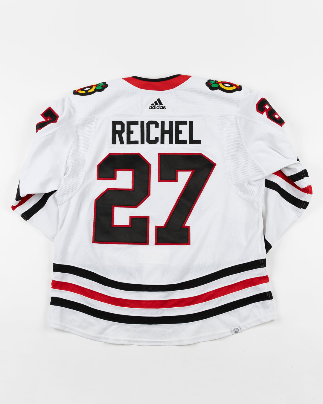 white adidas Chicago Blackhawks away jersey game used by player Lukas Reichel - back lay flat