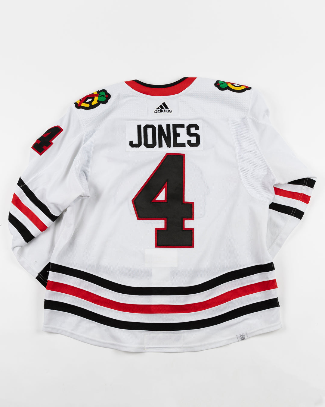 white adidas Chicago Blackhawks game used jersey used by Chicago Blackhawks player Seth Jones - back lay flat