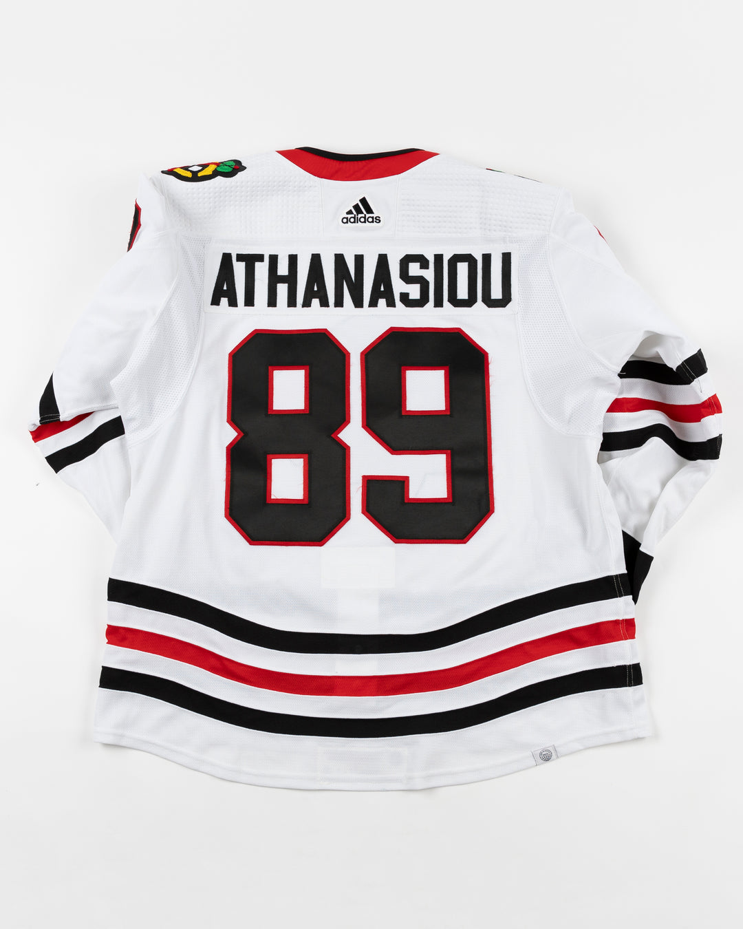 white adidas Chicago Blackhawks game used jersey used by Blackhawks player Andreas Athanasiou - back lay flat