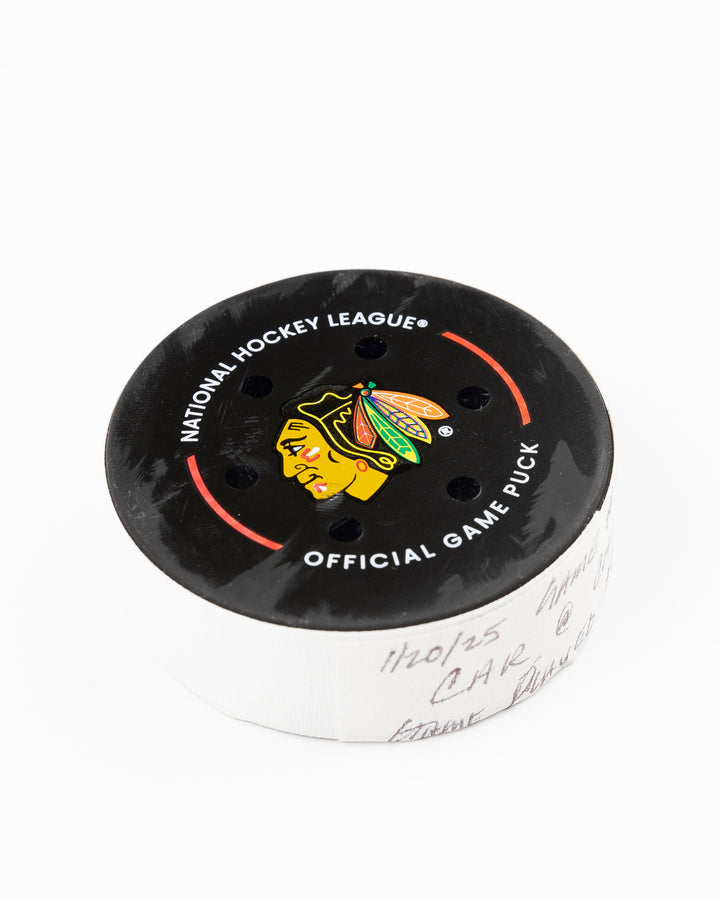 official Chicago Blackhawks game-used puck used against the Carolina Hurricanes on January 20, 2025 - front angle lay flat