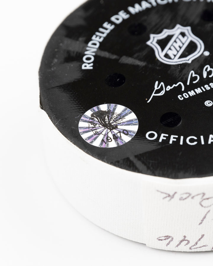 official Chicago Blackhawks game-used puck used against the Carolina Hurricanes on January 20, 2025 - hologram sticker detail lay flat