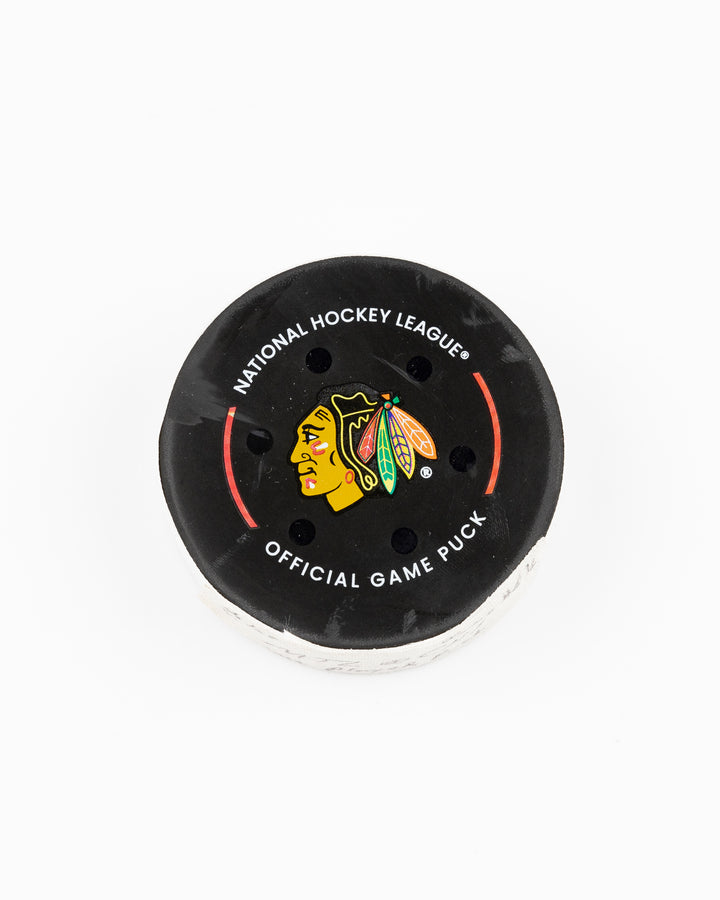 official Chicago Blackhawks game-used hockey puck used in the game against the Montreal Canadiens on January 3, 2025 - front lay flat