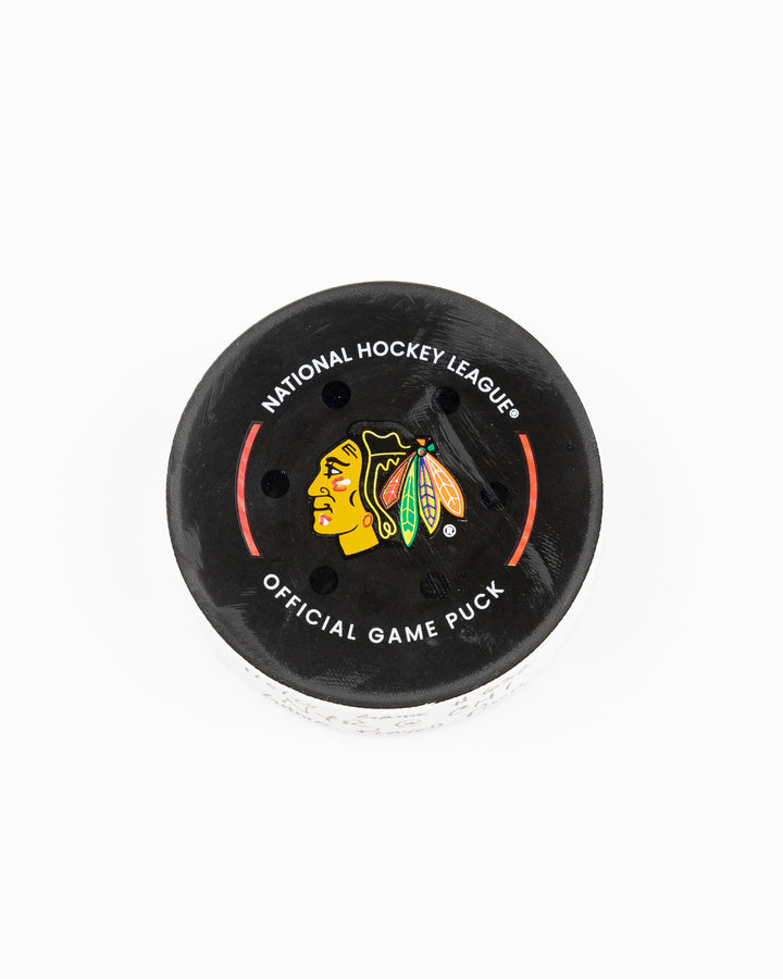 official Chicago Blackhawks game-used hockey puck used during game against the Colorado Avalanche on January 8, 2025 - front lay flat