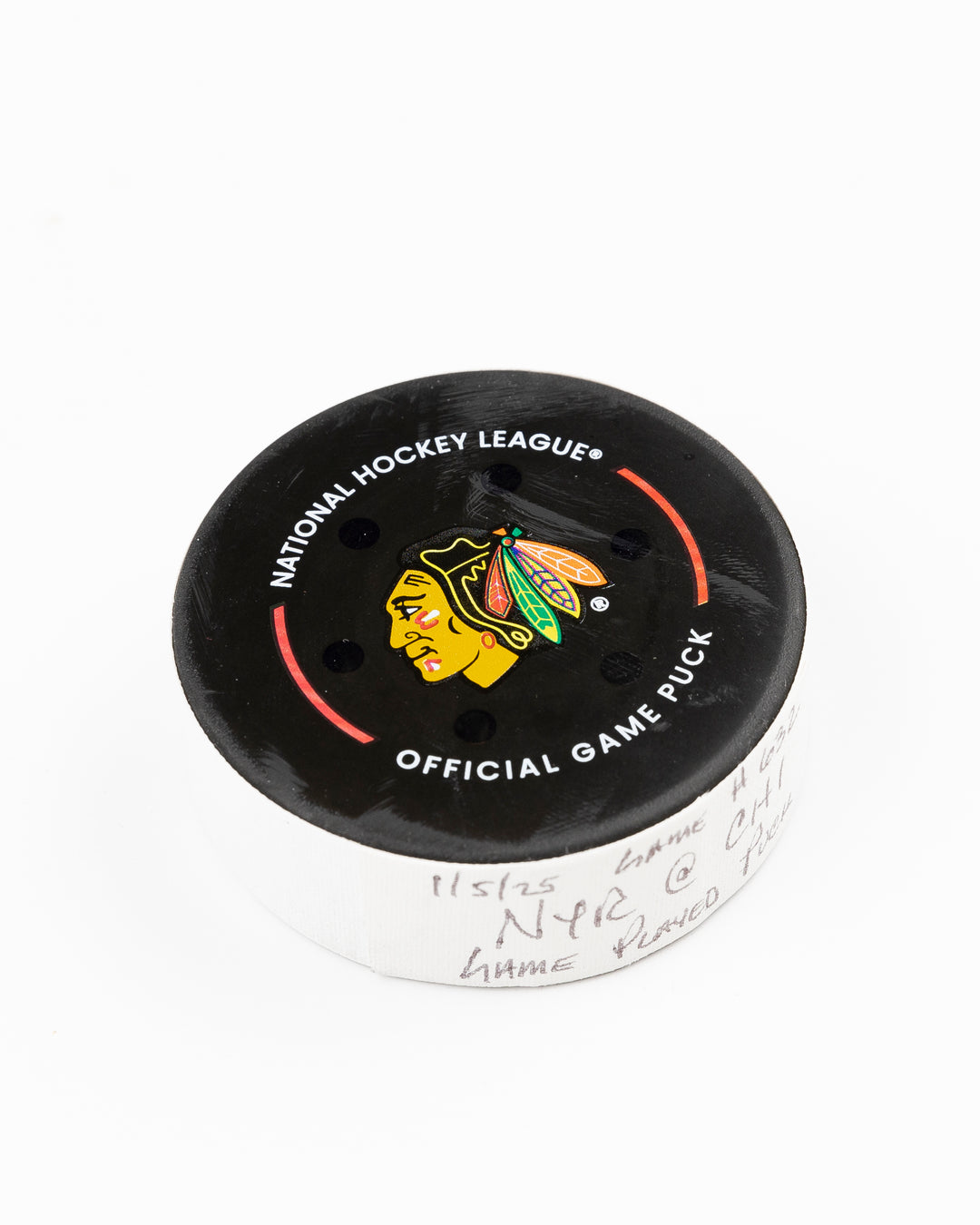 official Chicago Blackhawks game-used hockey puck used during game against the Colorado Avalanche on January 8, 2025 - front angle lay flat