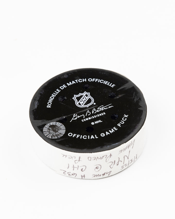 official Chicago Blackhawks game-used hockey puck used during game against the Colorado Avalanche on January 8, 2025 - back angle lay flat