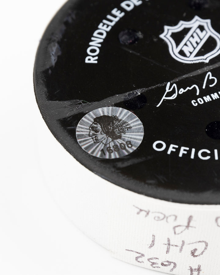 official Chicago Blackhawks game-used hockey puck used during game against the Colorado Avalanche on January 8, 2025 - hologram sticker detail lay flat