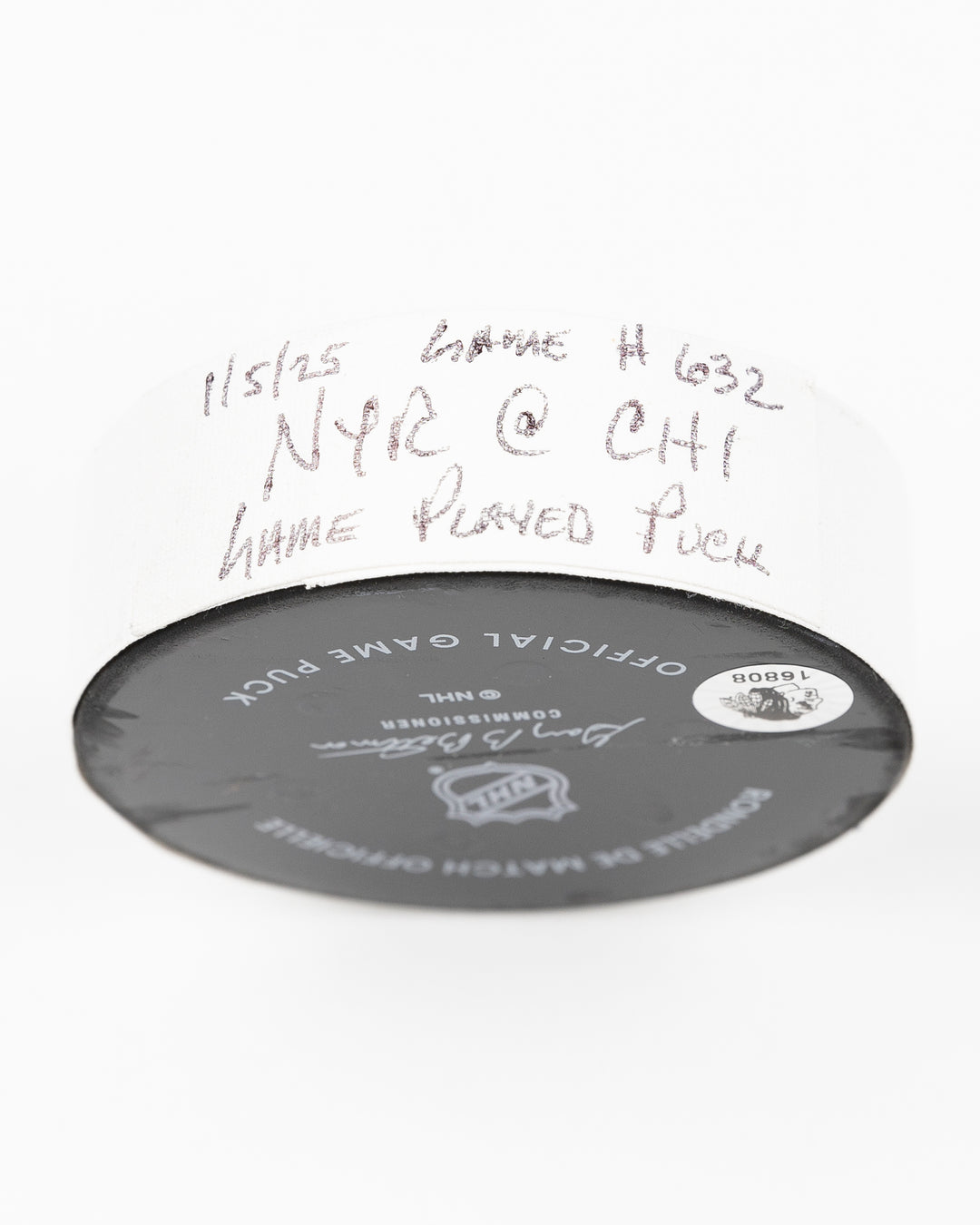 official Chicago Blackhawks game-used hockey puck used during game against the Colorado Avalanche on January 8, 2025 - tape detail lay flat