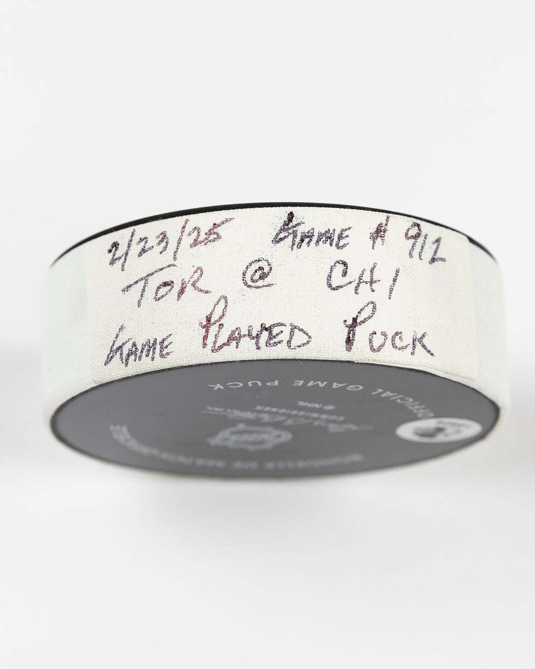 February 2025 official Chicago Blackhawks game-used hockey puck - tape detail lay flat