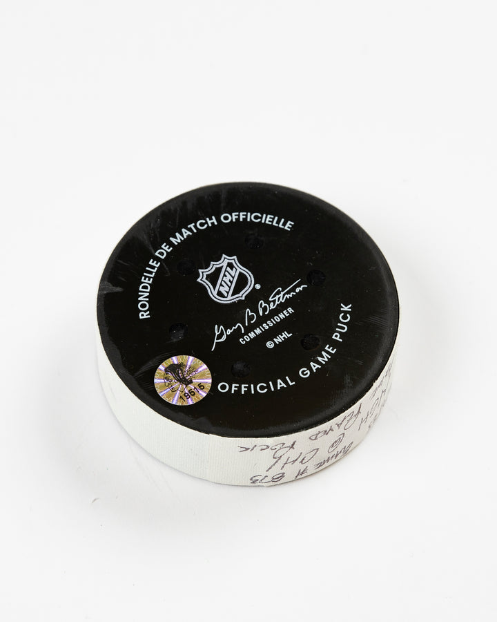 February 2025 official game-used Chicago Blackhawks hockey puck - back angle lay flat