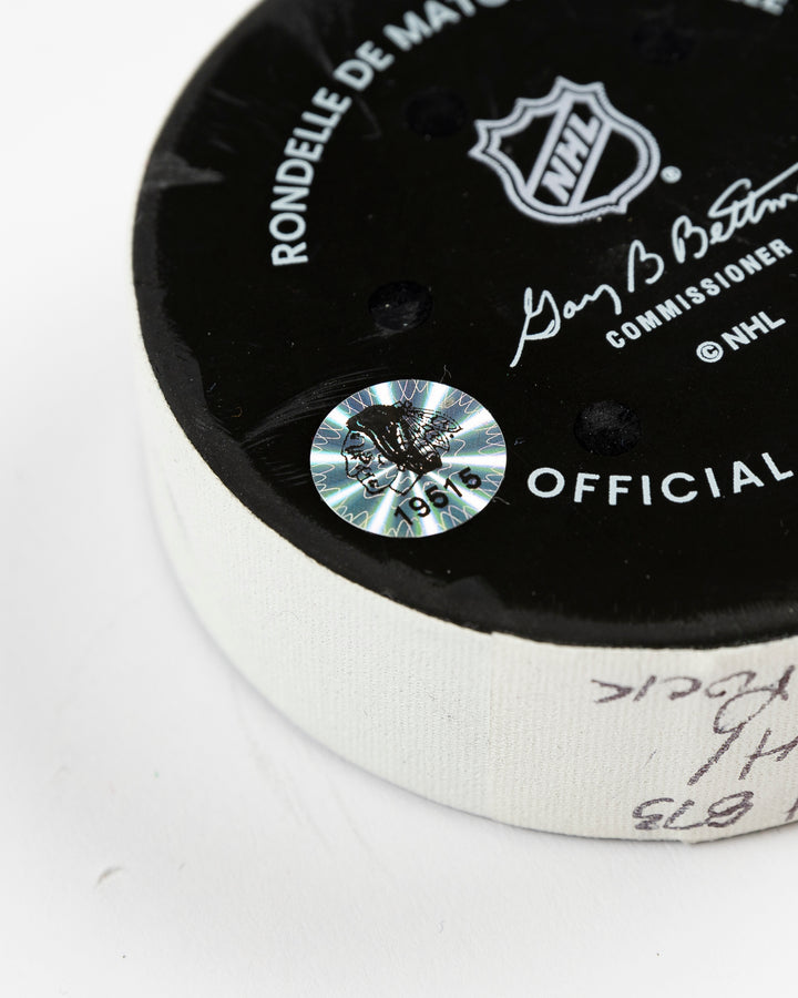 February 2025 official game-used Chicago Blackhawks hockey puck - hologram sticker detail lay flat