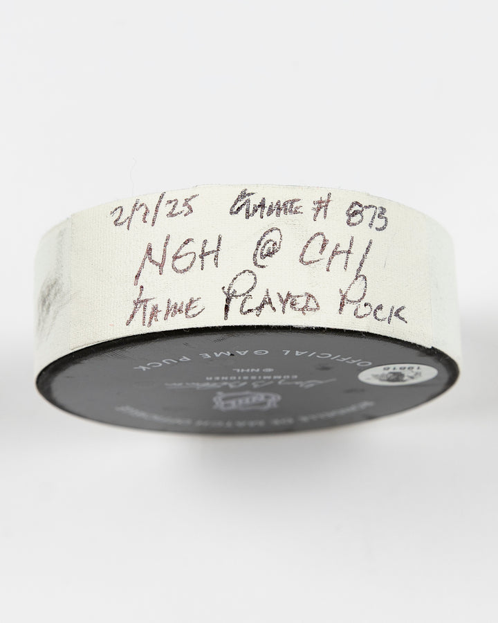 February 2025 official game-used Chicago Blackhawks hockey puck - tape detail lay flat