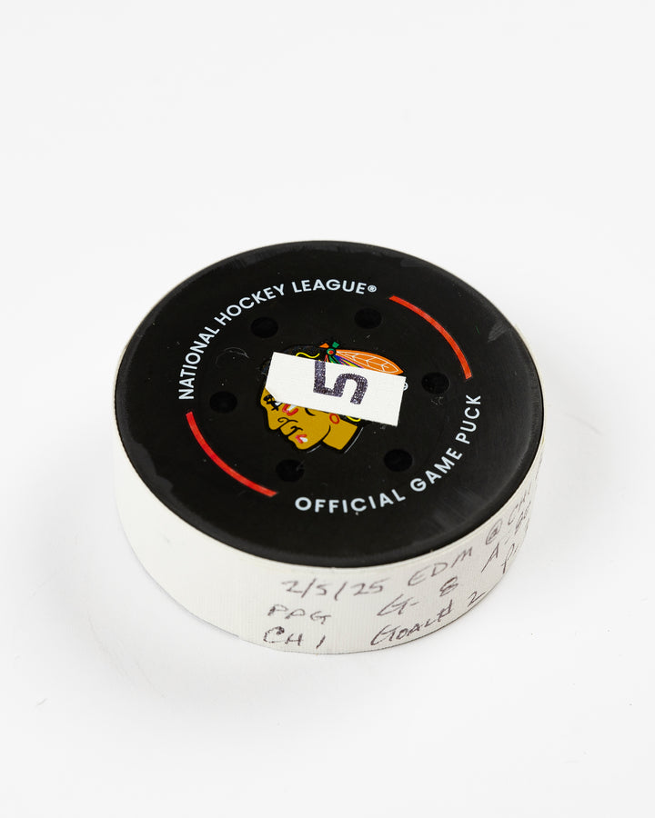 official Chicago Blackhawks game-used goal hockey puck scored by Ryan Donato against the Edmonton Oilers on February 5, 2025 - front angle ay flat