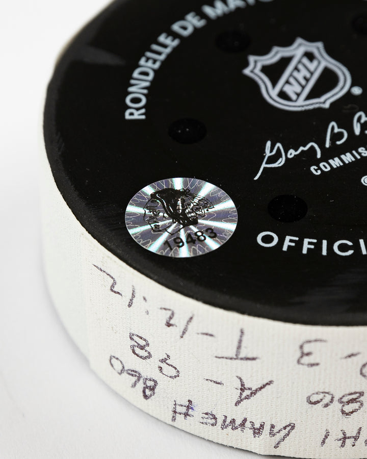 official Chicago Blackhawks game-used goal hockey puck scored by Ryan Donato against the Edmonton Oilers on February 5, 2025 - hologram sticker detail lay flat