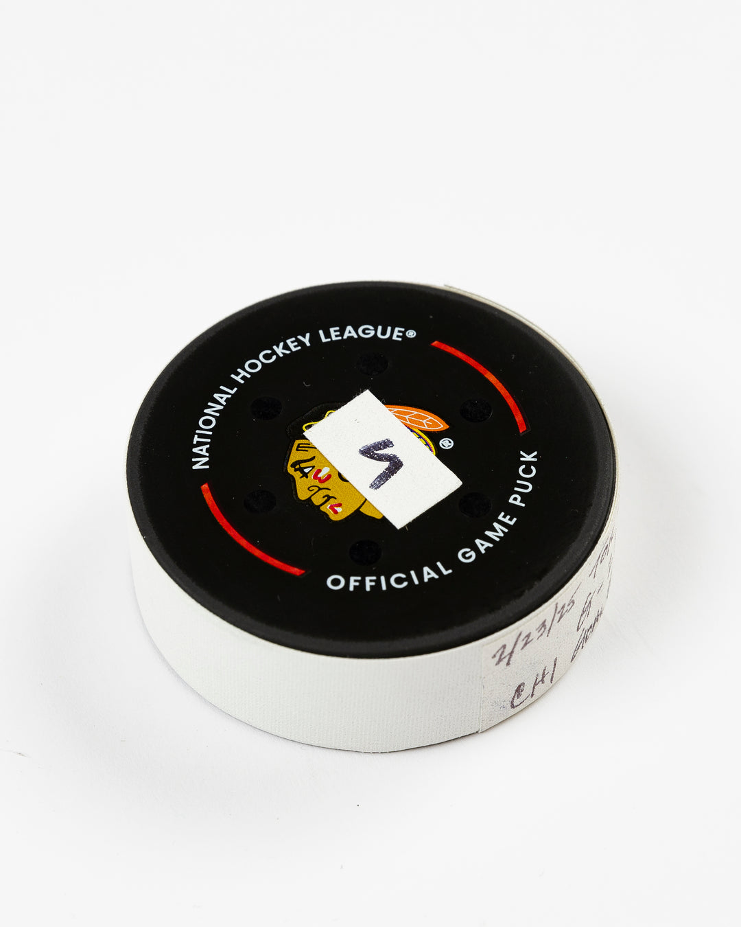 official Chicago Blackhawks game-used goal puck scored by Philipp Kurashev against the Toronto Maple Leaves on February 23, 2025 - front angle lay flat