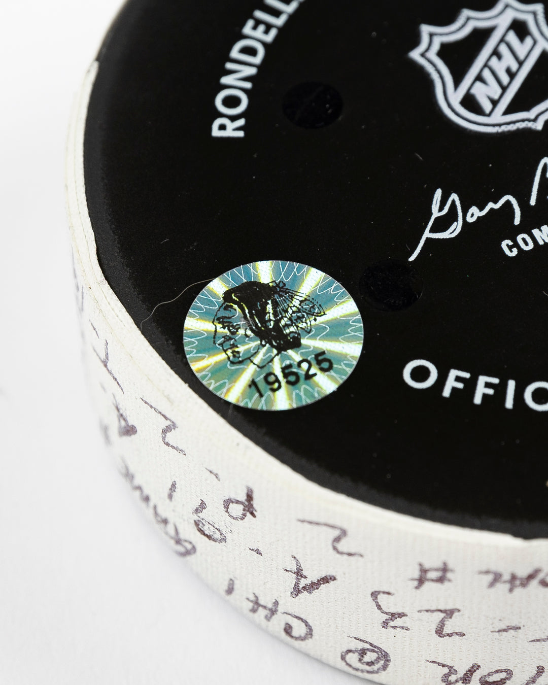 official Chicago Blackhawks game-used goal puck scored by Philipp Kurashev against the Toronto Maple Leaves on February 23, 2025 - hologram sticker detail lay flat