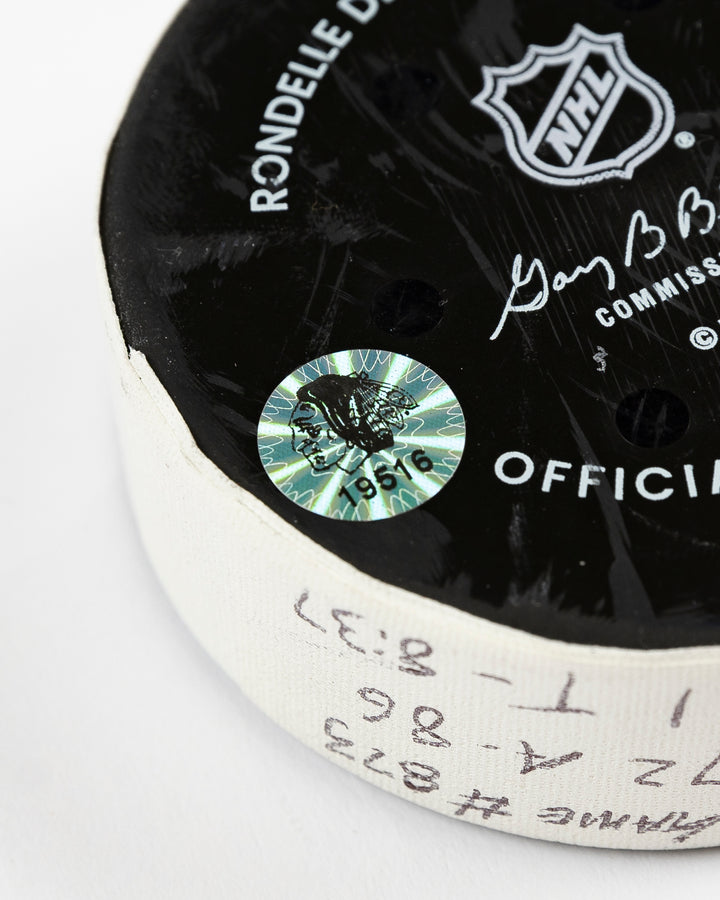 official Chicago Blackhawks game-used goal puck scored by Frank Nazar on February 7, 2025 against Nashville Predators - hologram sticker detail lay flat