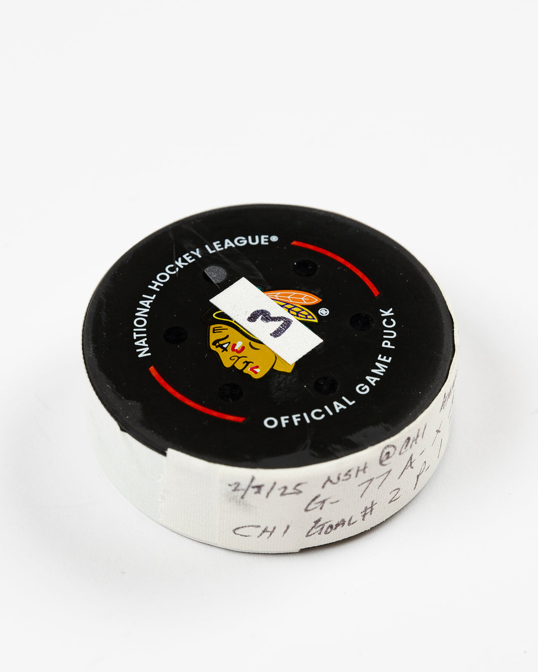 official Chicago Blackhawks game-used goal puck scored by Pat Maroon on February 7, 2025 against the Edmonton Oilers - front angle lay flat