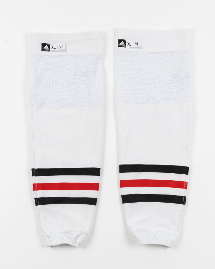 white adidas hockey socks used by Chicago Blackhawks goalie Petr Mrazek - front lay flat