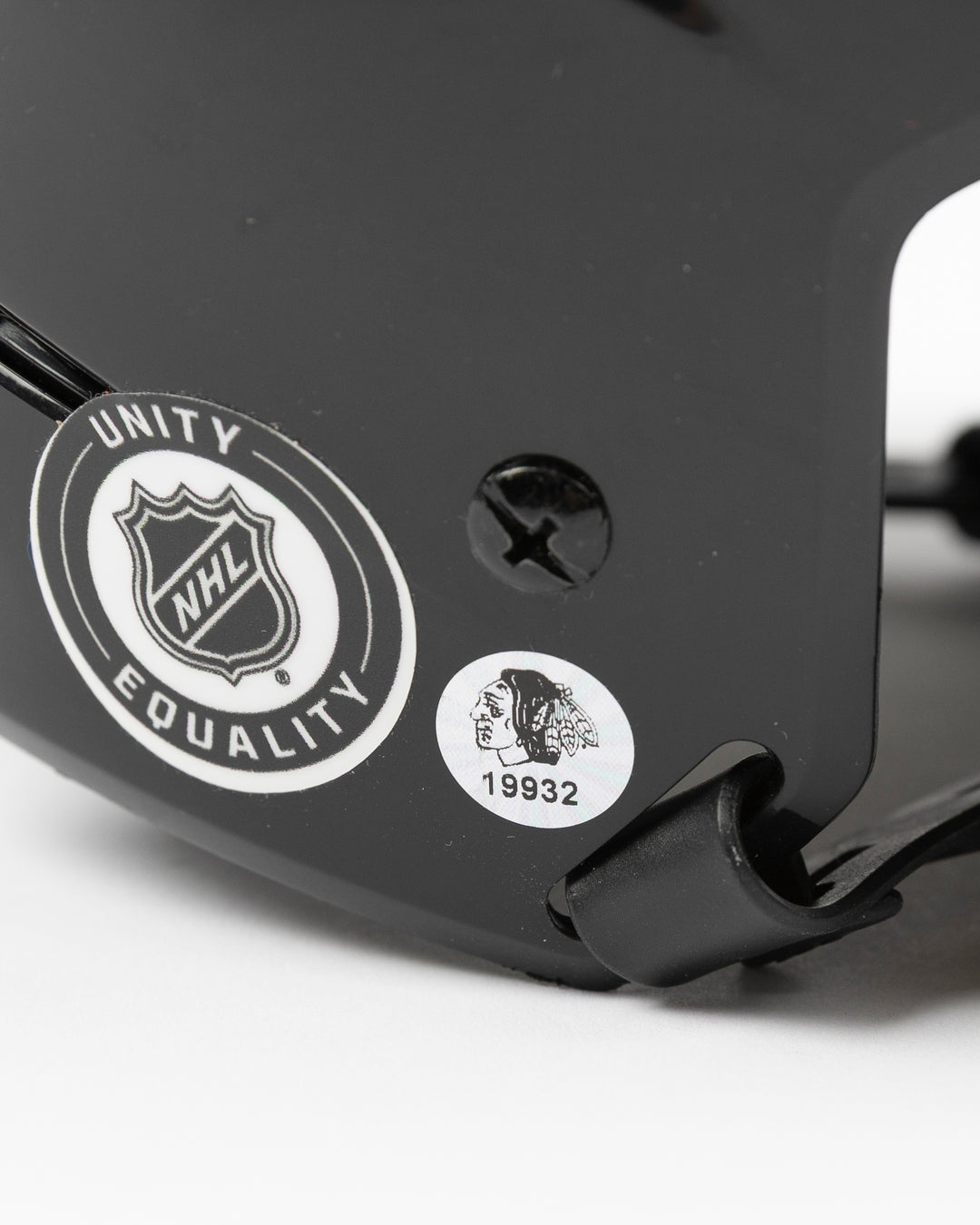 black Warrior brand hockey helmet used by Chicago Blackhawks player Joey Anderson - hologram sticker detail lay flat