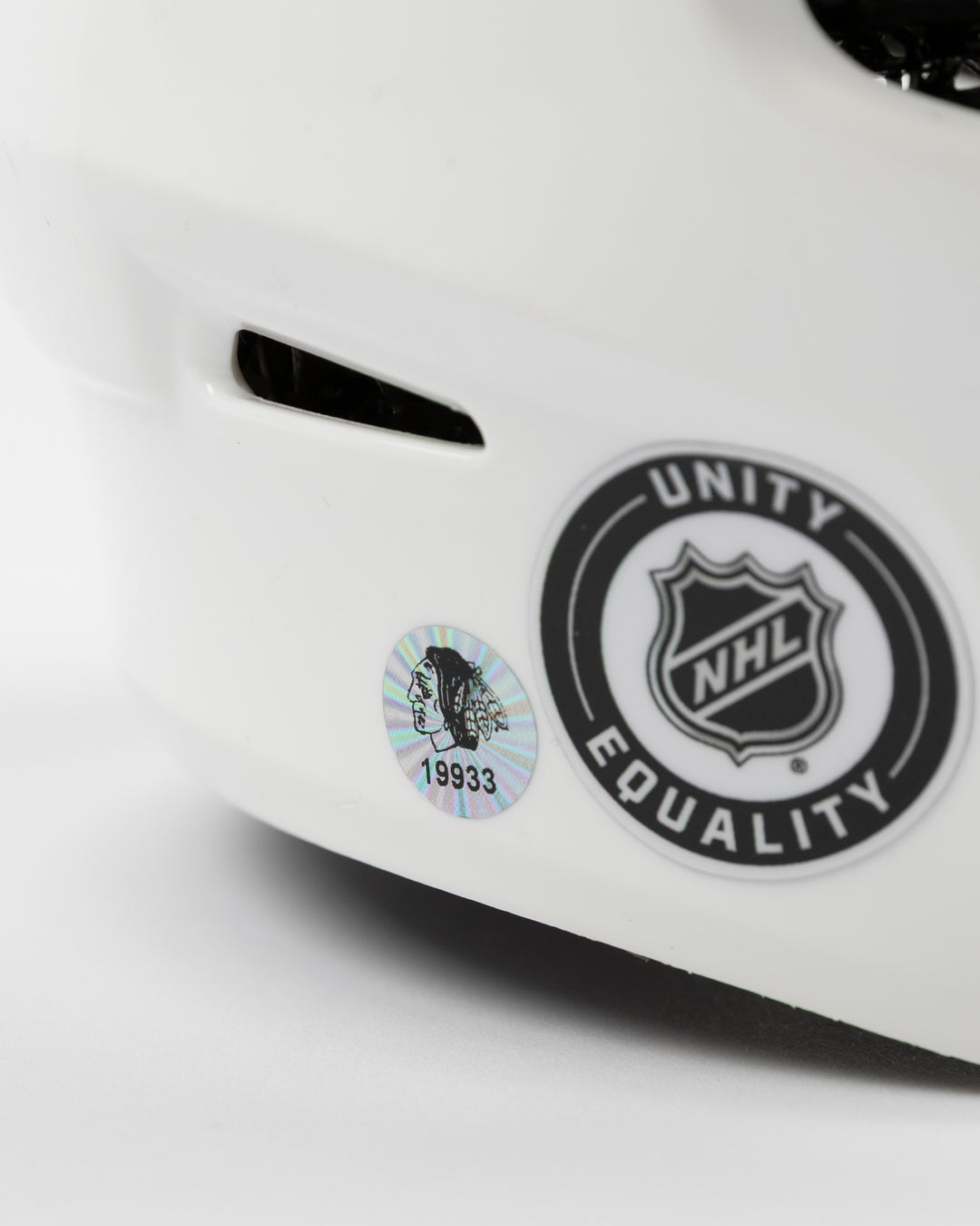 white CCM hockey helmet worn and used by Chicago Blackhawks player Cole Guttman - hologram sticker detail lay flat